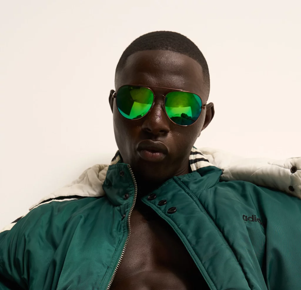 Man wearing green mirrored aviators 